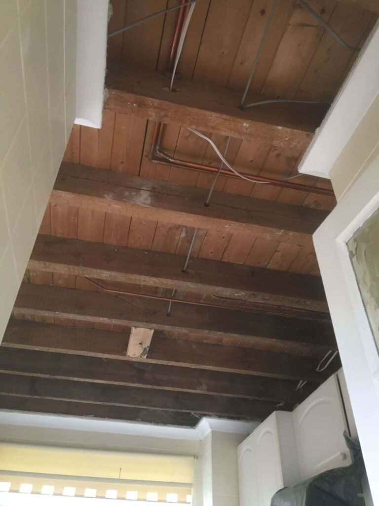 This is a photo of a ceiling that has been stripped back to the joists, due to a leak, and is now ready for re-boarding.