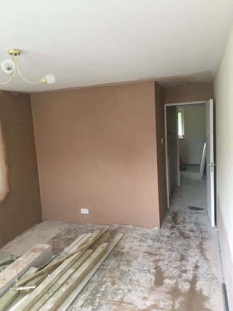 This is a photo of a bedroom which has just had new plaster applied over new plasterboard